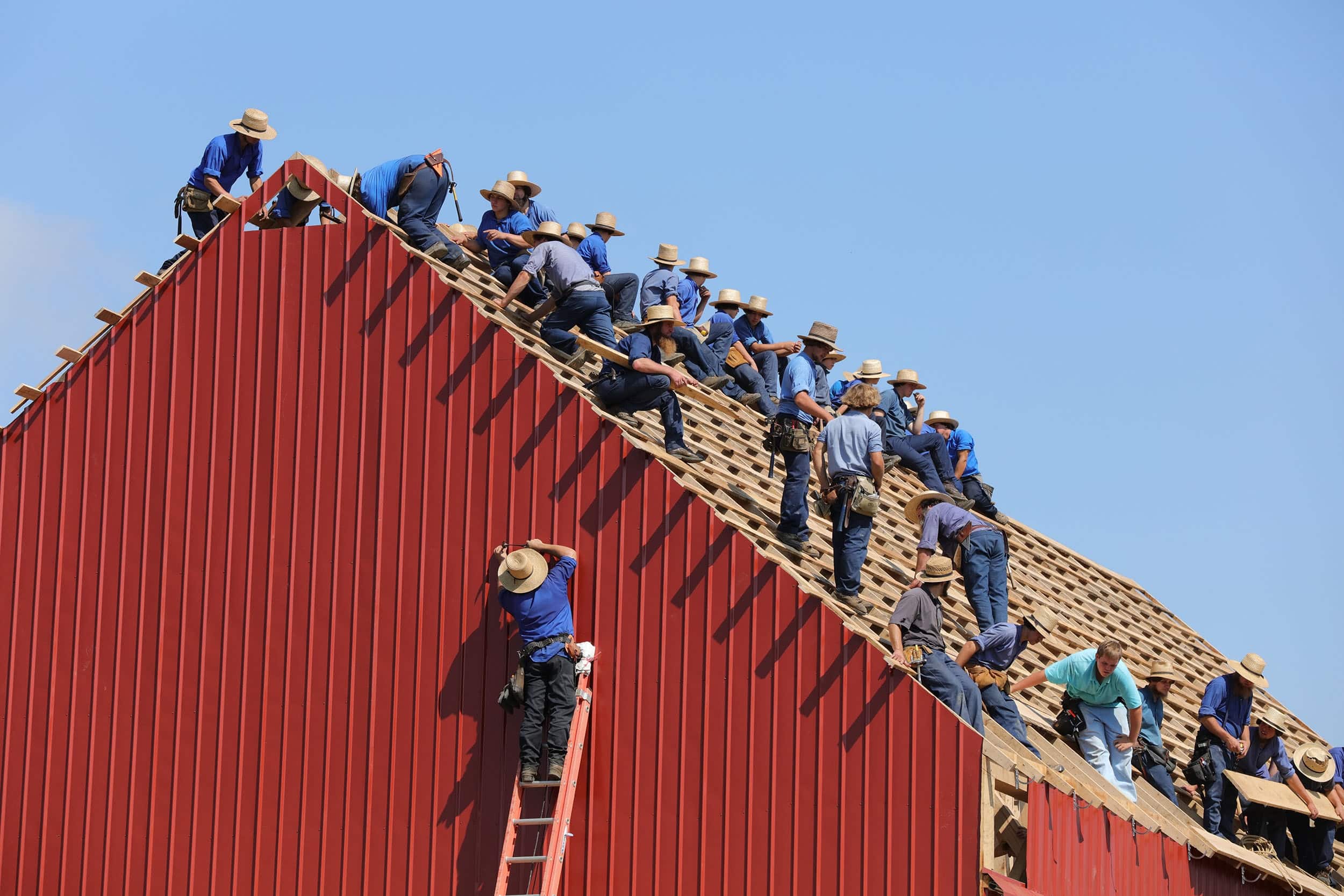 men working together on a barn-raising